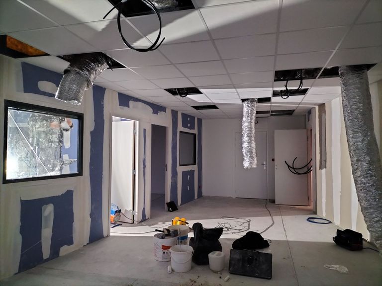 Cloisons et plafond de bureaux en cours de finition, bandes en place